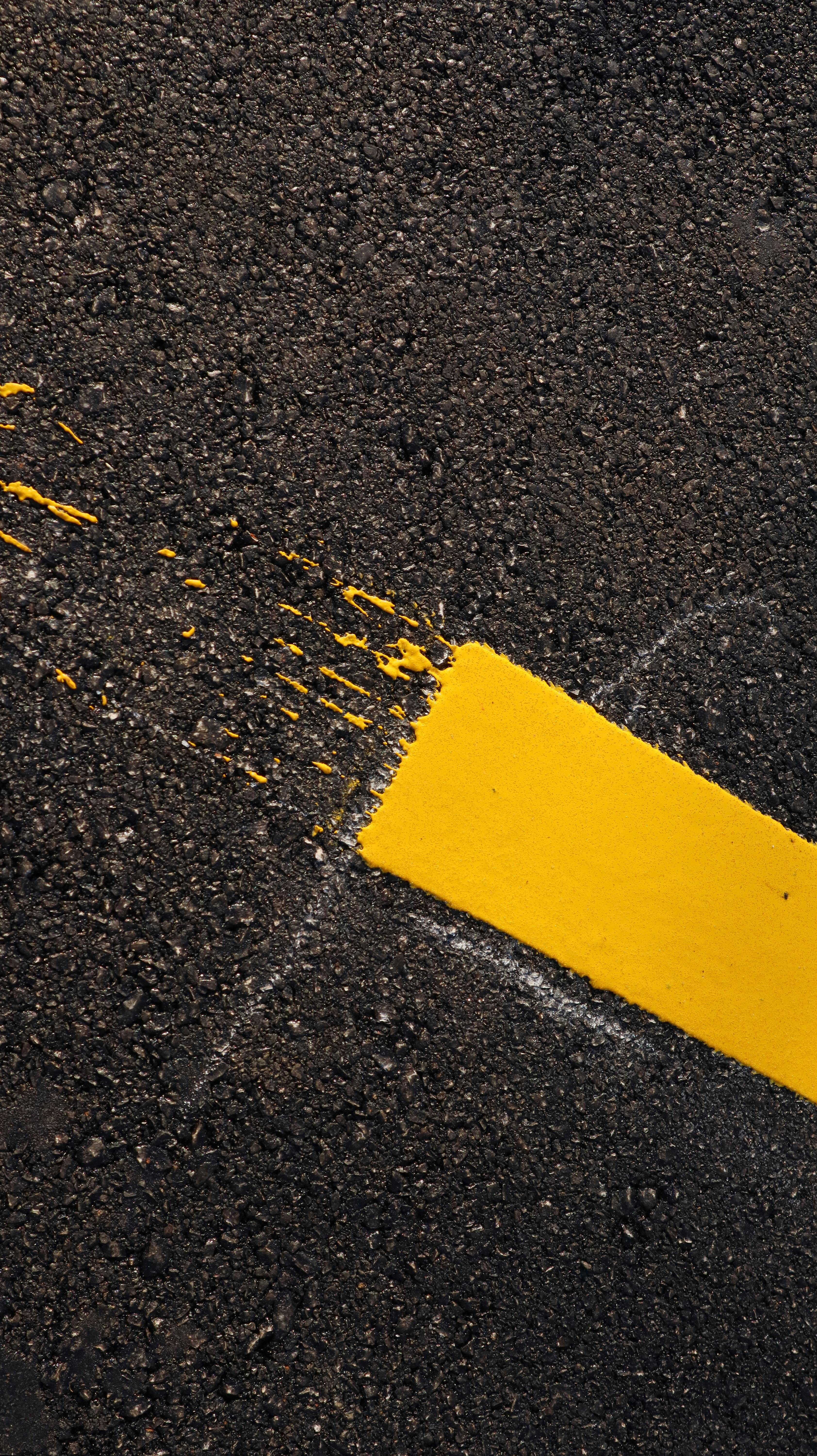 Fresh yellow road line paint application