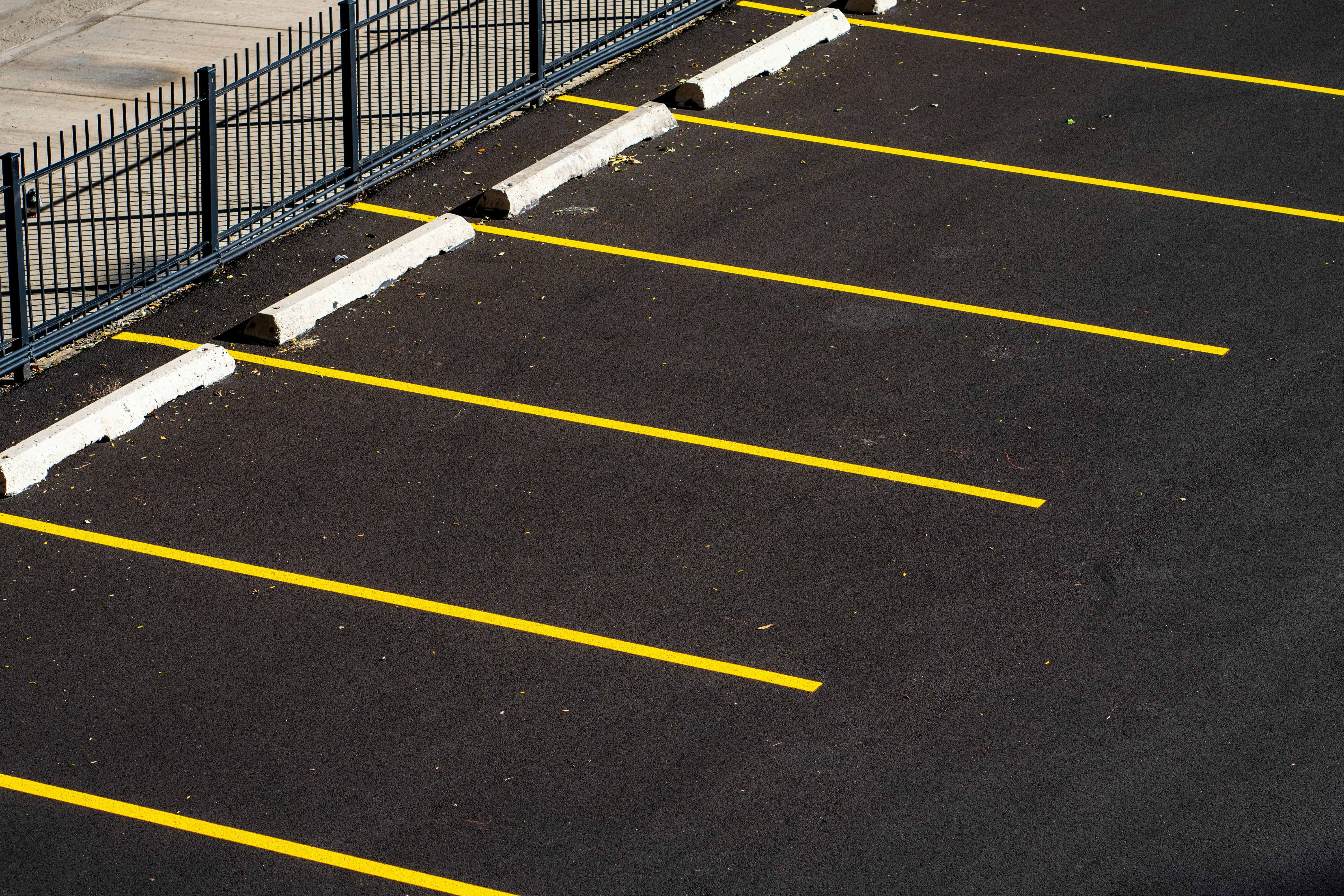 Fresh yellow parking lot striping by 777 Striping in Colorado